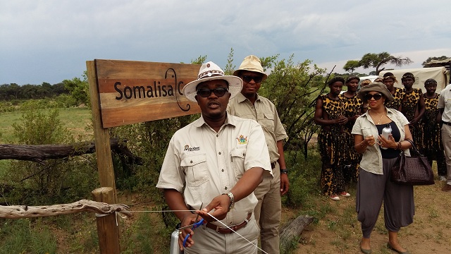 Minister Mzembi cuts ribbon at somalisa camp to officially open the refurbished camp. looking on are bekezela ndlovu the ceo of african bush camps and mrs barbara mzembi  